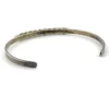 Vintage sterling silver cuff bracelet with eleven small turquoise snake-eye cabochons.