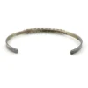 Vintage sterling silver cuff bracelet with eleven small turquoise snake-eye cabochons.