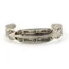 Vintage 1920s–1930s Navajo Fred Harvey era silver cuff bracelet with applied arrows, hand stamped motifs, and lizard-like markings.