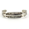 Vintage 1920s–1930s Navajo Fred Harvey era silver cuff bracelet with applied arrows, hand stamped motifs, and lizard-like markings.
