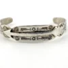 Vintage 1920s–1930s Navajo Fred Harvey era silver cuff bracelet with applied arrows, hand stamped motifs, and lizard-like markings.