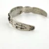 Vintage 1920s–1930s Navajo Fred Harvey era silver cuff bracelet with applied arrows, hand stamped motifs, and lizard-like markings.