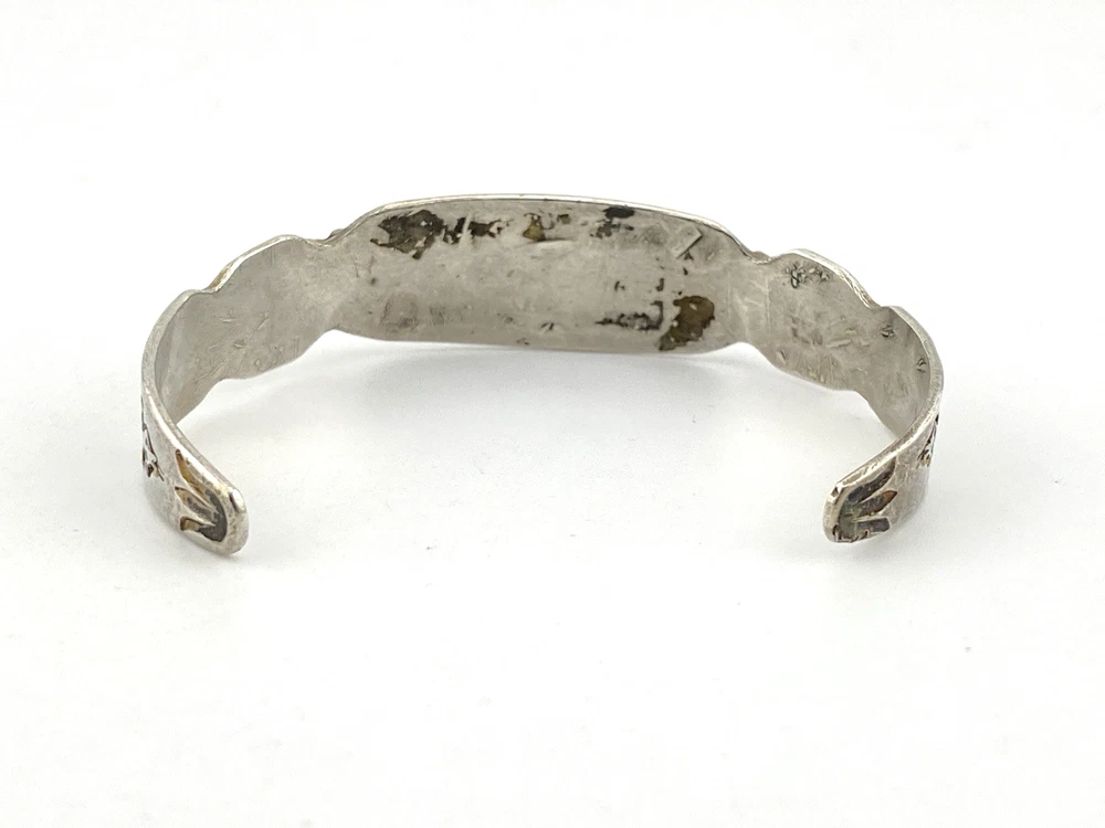 Vintage 1920s–1930s Navajo Fred Harvey era silver cuff bracelet with applied arrows, hand stamped motifs, and lizard-like markings.