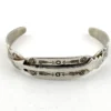 Vintage 1920s–1930s Navajo Fred Harvey era silver cuff bracelet with applied arrows, hand stamped motifs, and lizard-like markings.