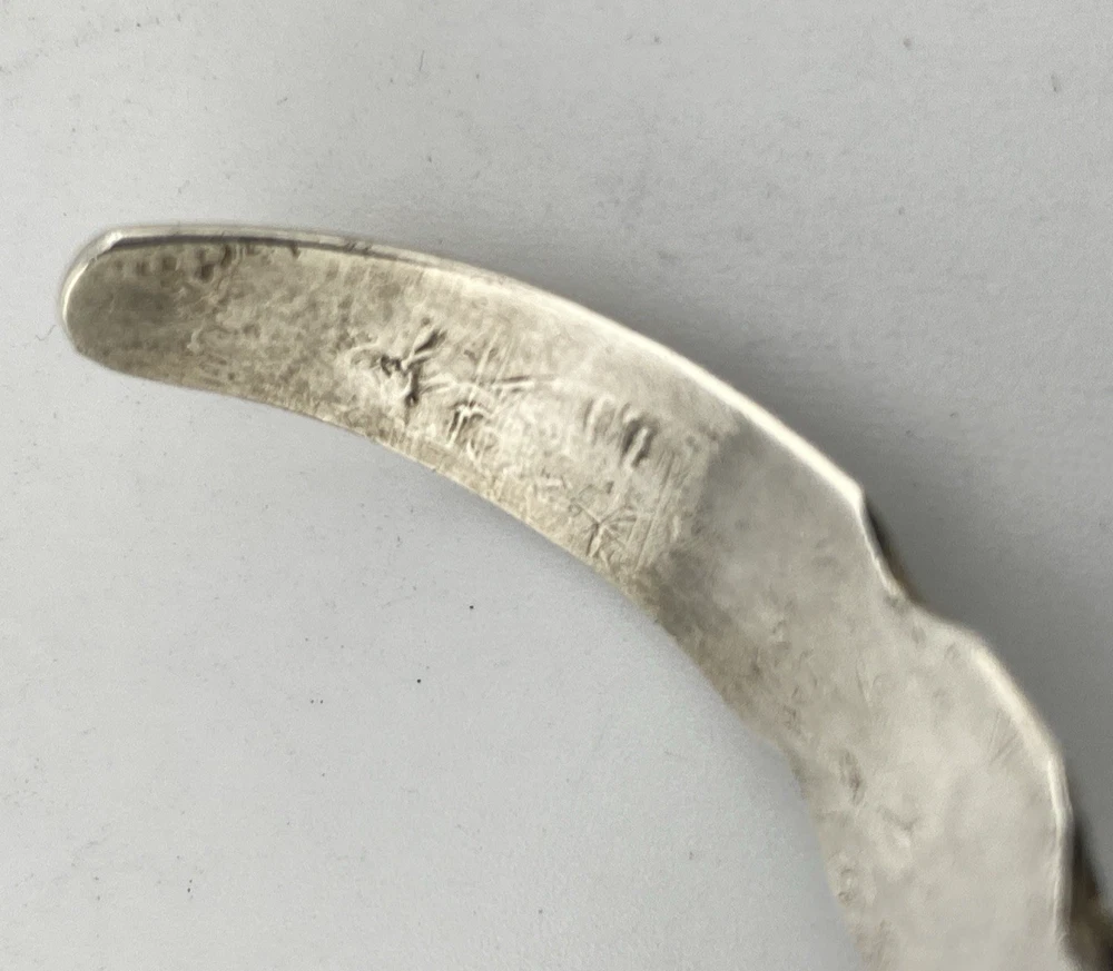 Vintage 1920s–1930s Navajo Fred Harvey era silver cuff bracelet with applied arrows, hand stamped motifs, and lizard-like markings.