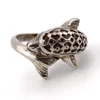 Vintage sterling silver dolphin bypass ring with carved figural details and dark patina.