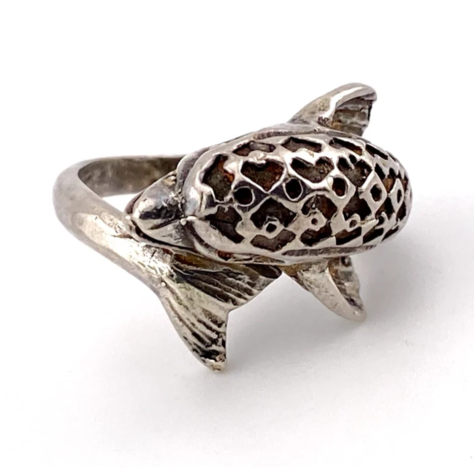 Vintage sterling silver dolphin bypass ring with carved figural details and dark patina.
