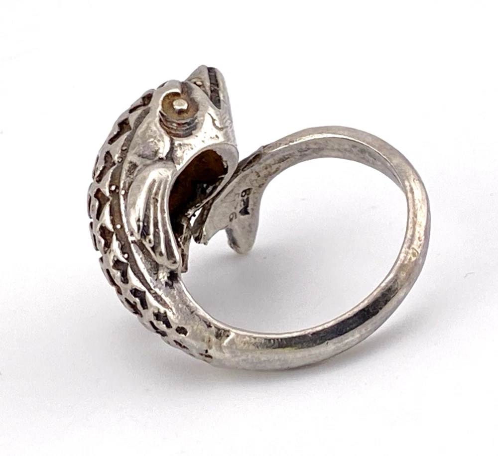 Vintage sterling silver dolphin bypass ring with carved figural details and dark patina.