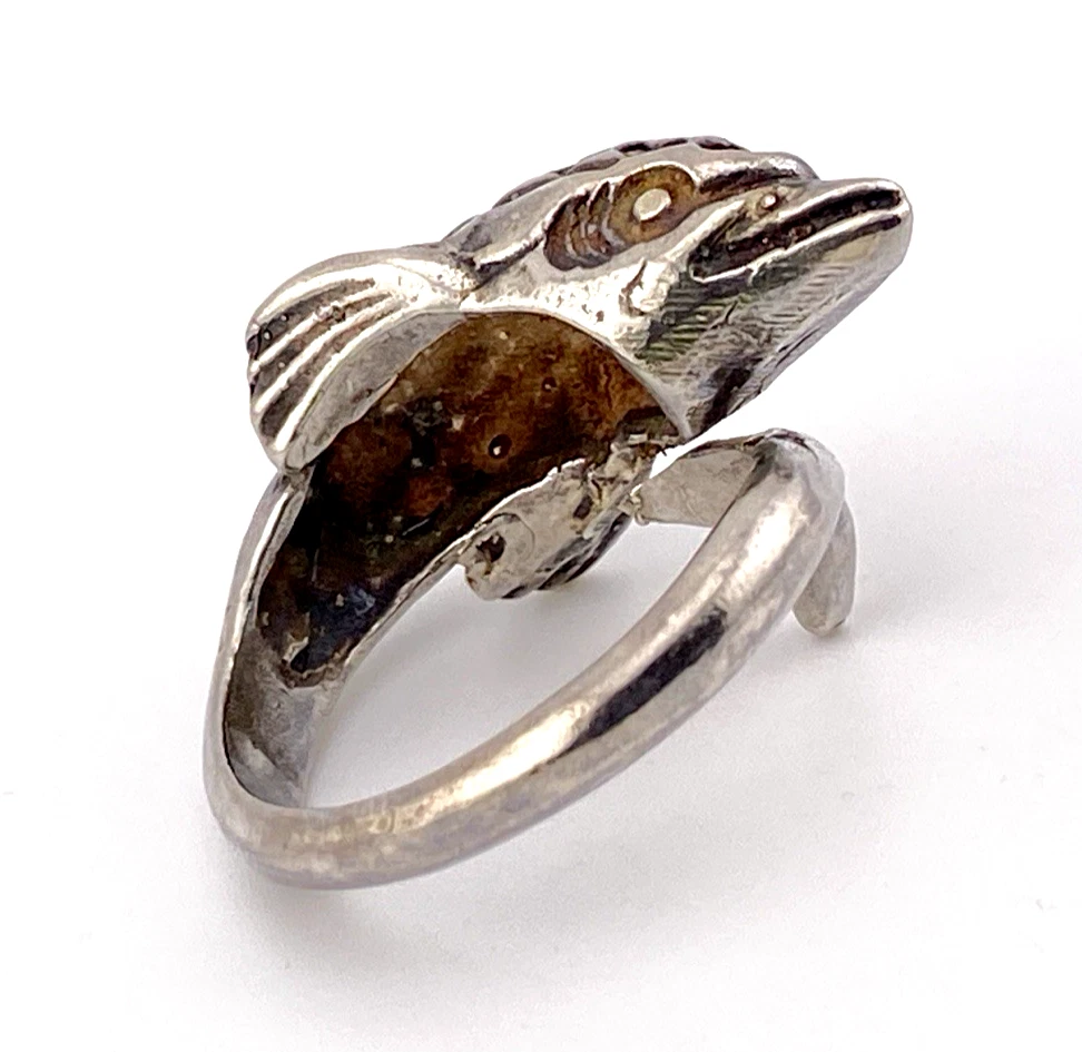 Vintage sterling silver dolphin bypass ring with carved figural details and dark patina.