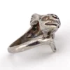 Vintage sterling silver dolphin bypass ring with carved figural details and dark patina.
