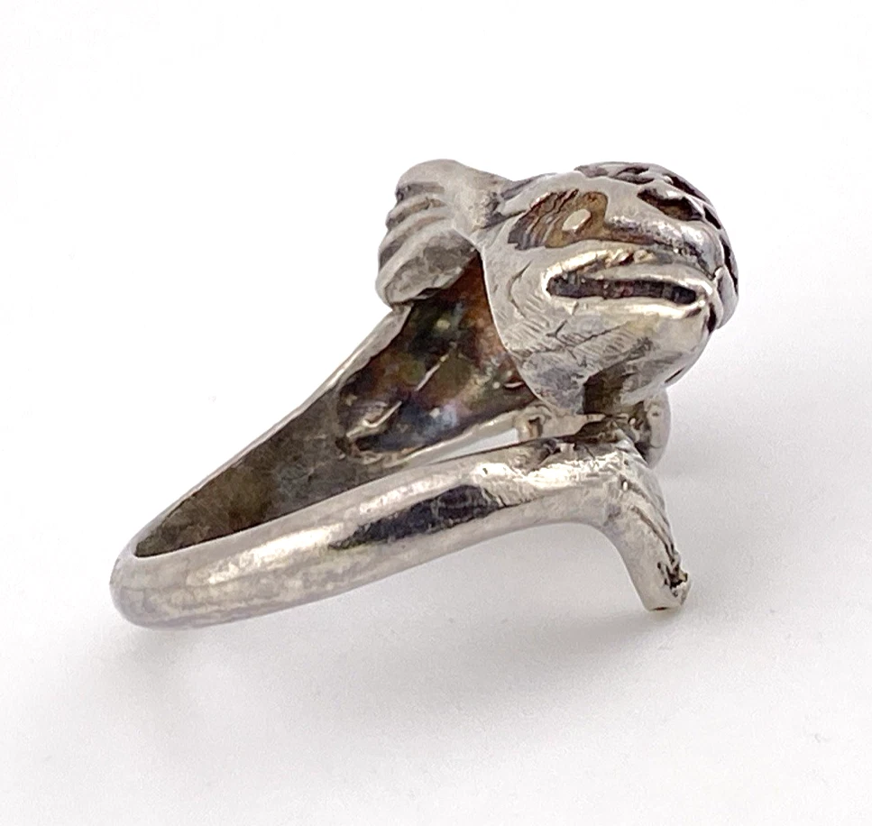 Vintage sterling silver dolphin bypass ring with carved figural details and dark patina.