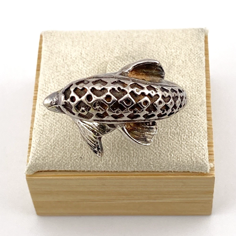 Vintage sterling silver dolphin bypass ring with carved figural details and dark patina.