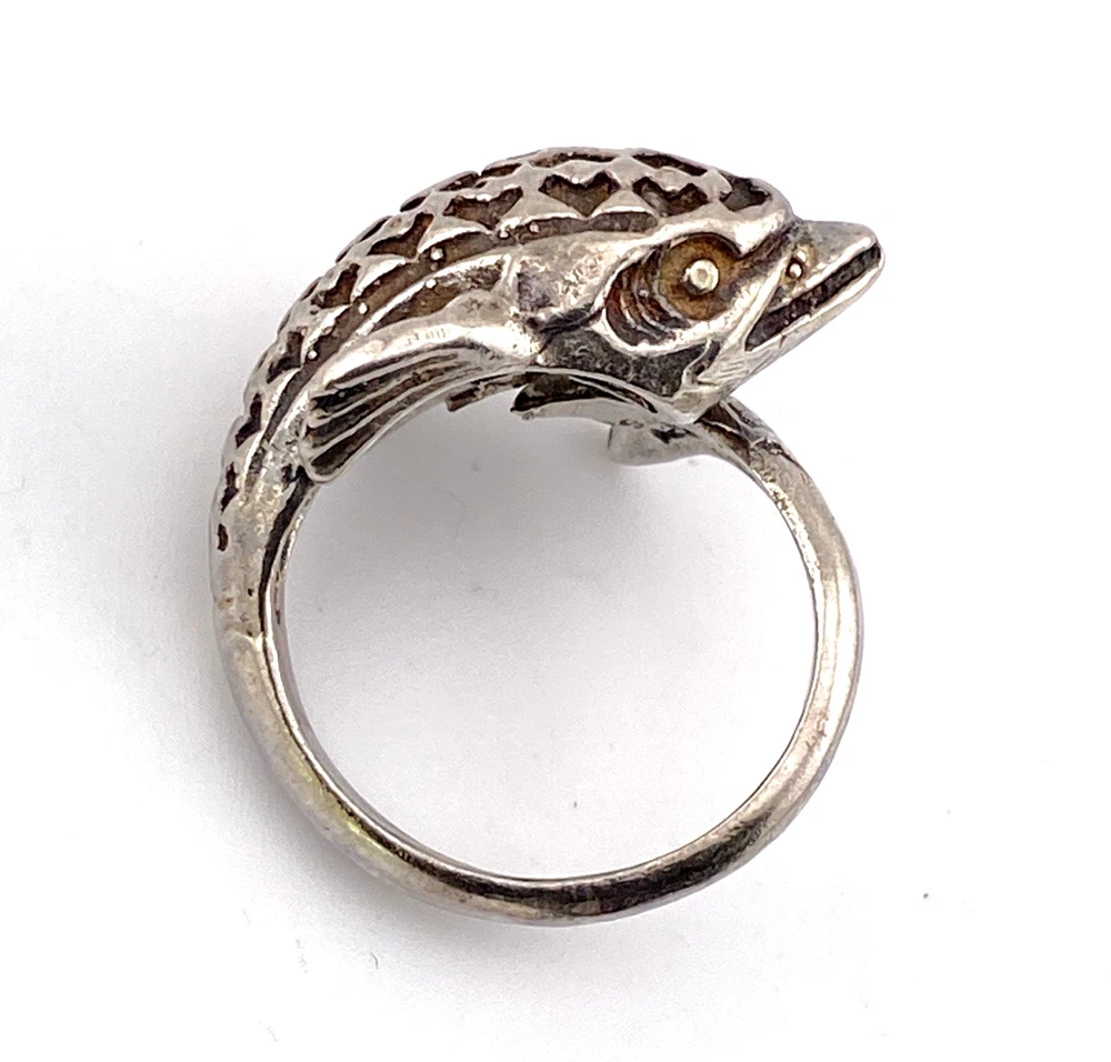 Vintage sterling silver dolphin bypass ring with carved figural details and dark patina.