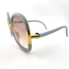 Gold tone hinge detail on Ted Lapidus sunglasses