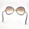 Brown gradient lenses on gray Ted Lapidus sunglasses