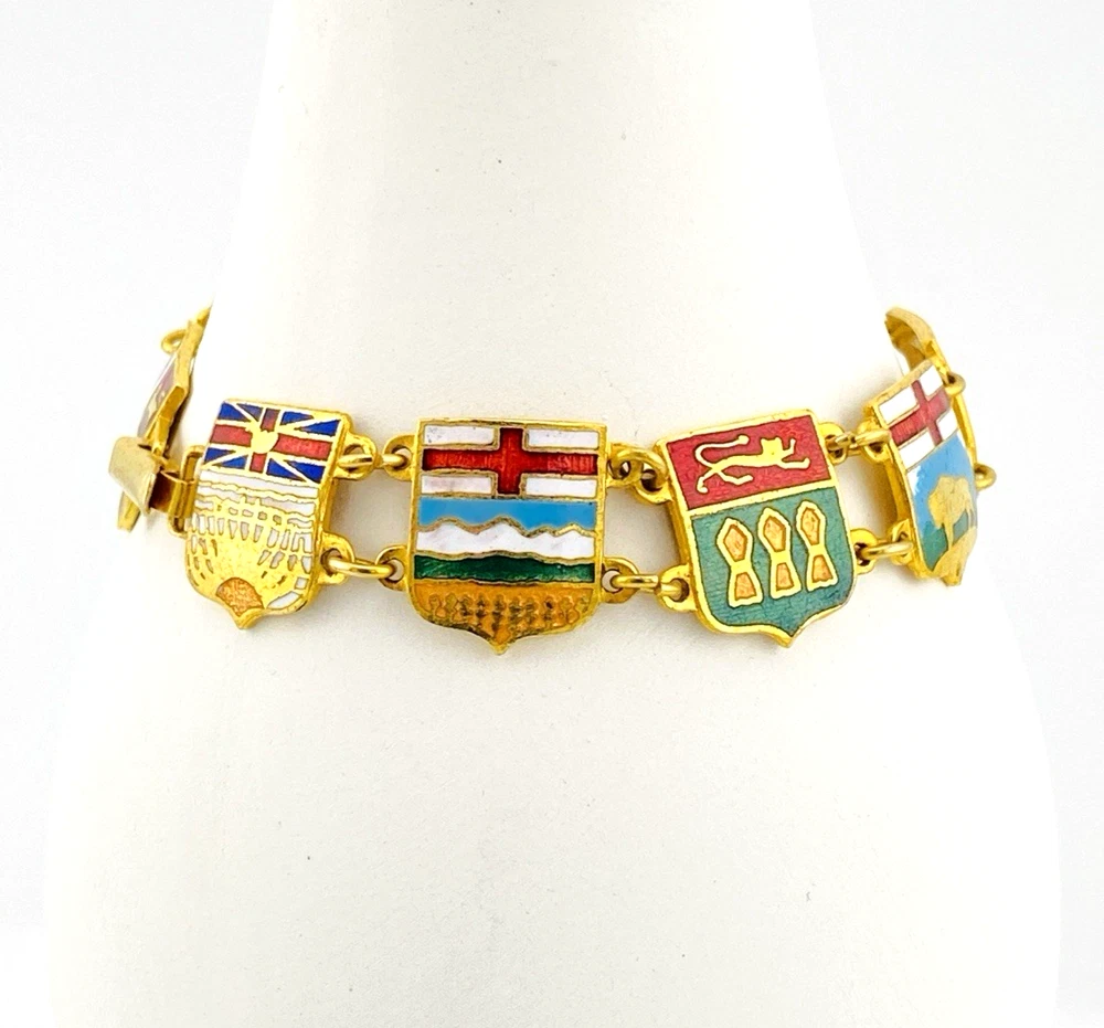 Vintage Canada souvenir bracelet with colorful enameled provincial shield links and gold plated finish