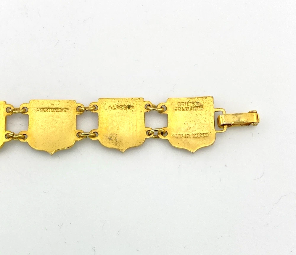 Vintage Canada souvenir bracelet with colorful enameled provincial shield links and gold plated finish