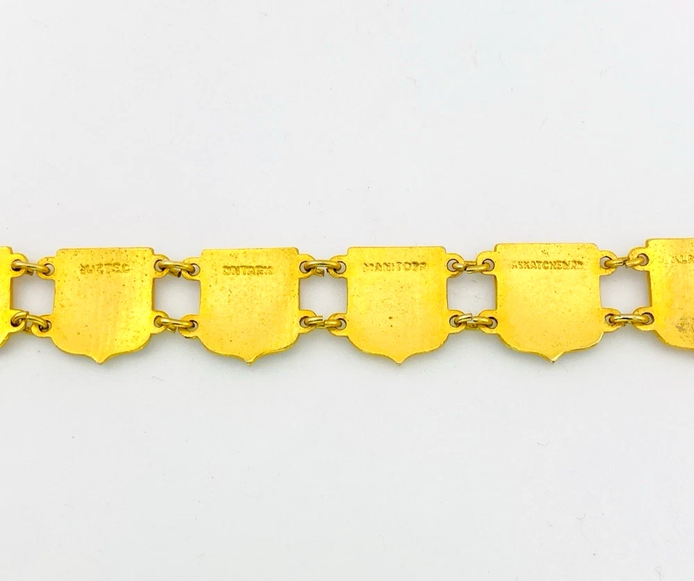 Vintage Canada souvenir bracelet with colorful enameled provincial shield links and gold plated finish