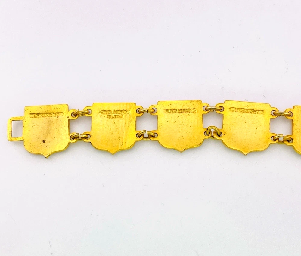 Vintage Canada souvenir bracelet with colorful enameled provincial shield links and gold plated finish