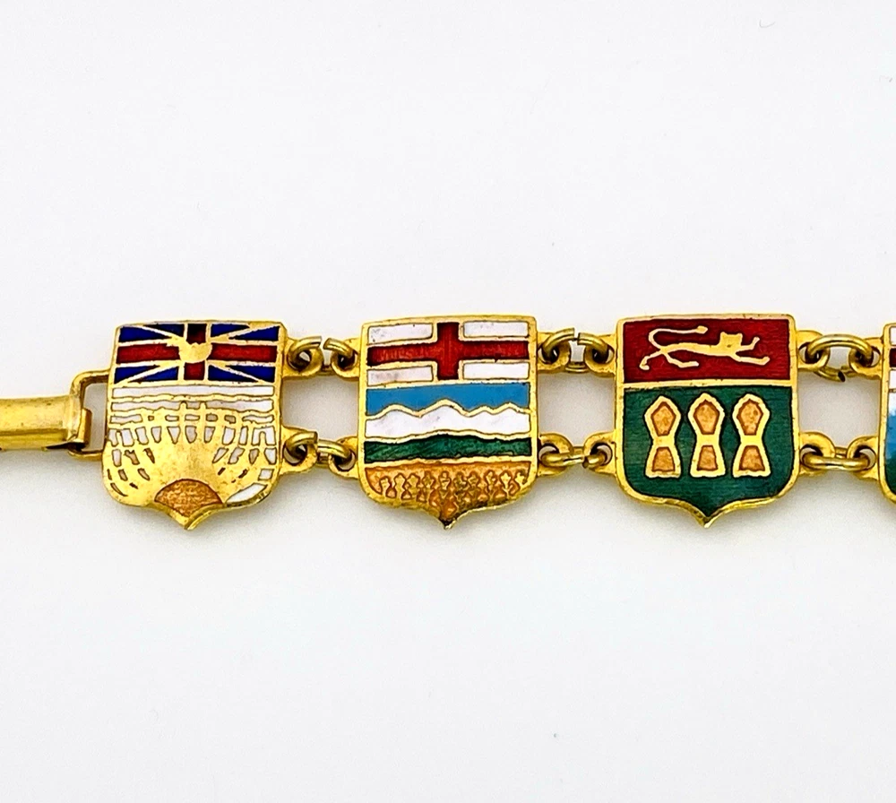 Vintage Canada souvenir bracelet with colorful enameled provincial shield links and gold plated finish