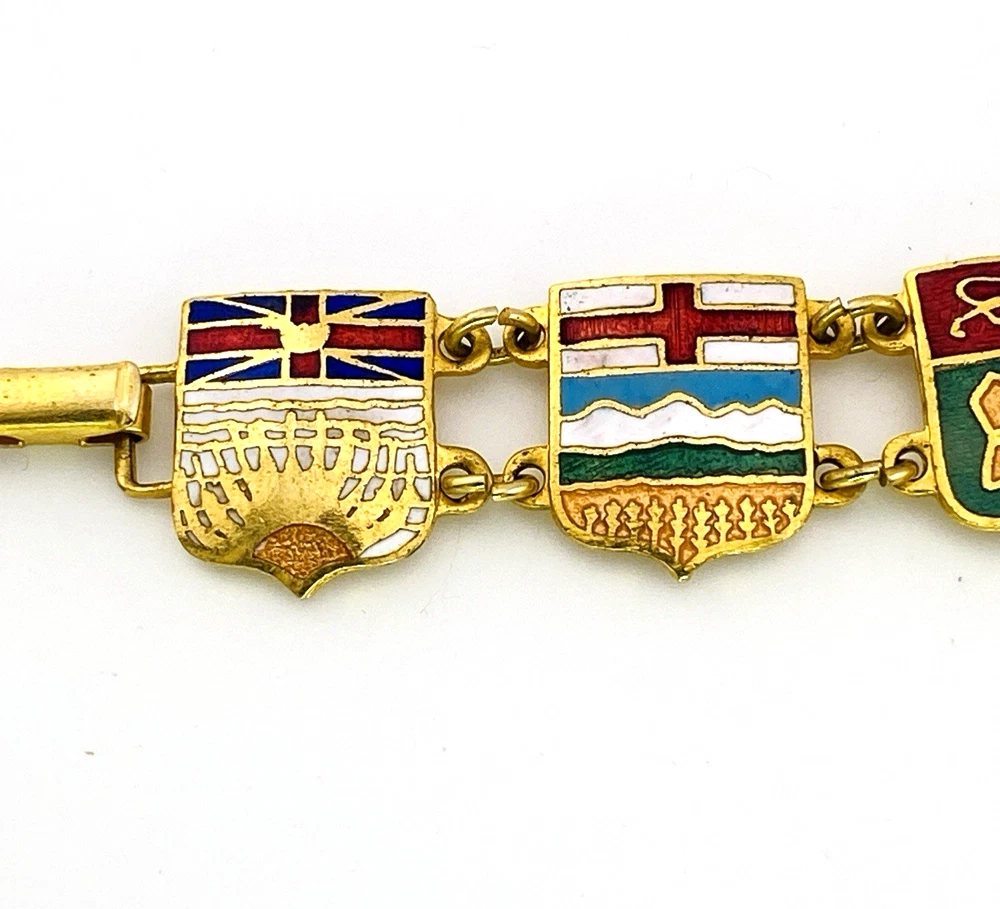 Vintage Canada souvenir bracelet with colorful enameled provincial shield links and gold plated finish