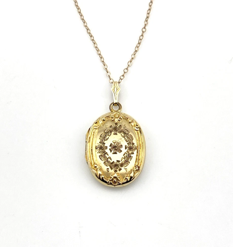 Vintage F.M. Co 1/20 10K gold filled oval locket necklace with hand engraved floral center, raised frame, and 19.5 inch chain