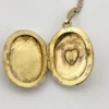 Vintage F.M. Co 1/20 10K gold filled oval locket necklace with hand engraved floral center, raised frame, and 19.5 inch chain