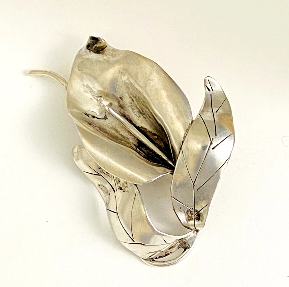 Vintage Modernist sterling silver calla lily brooch signed PA Reg with dimensional handmade leaves and heavy patina.