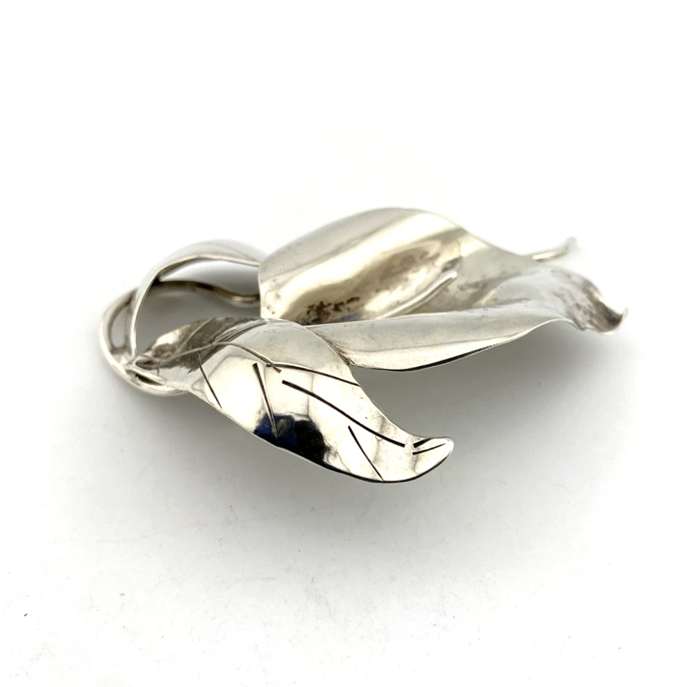 Vintage Modernist sterling silver calla lily brooch signed PA Reg with dimensional handmade leaves and heavy patina.