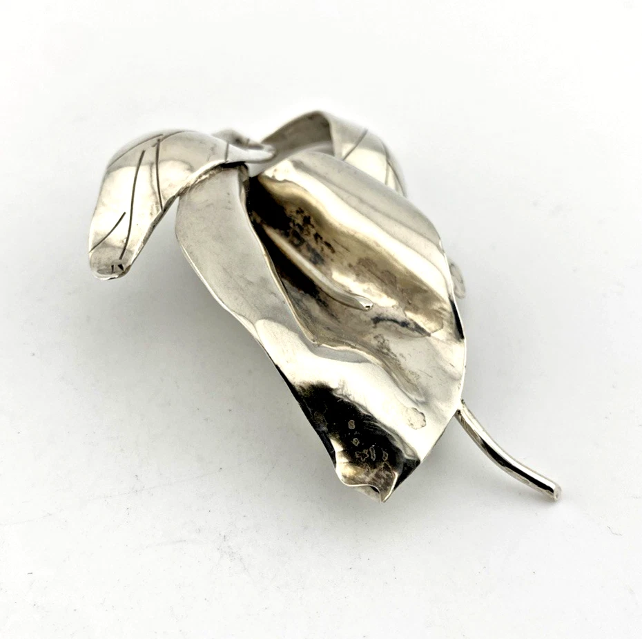 Vintage Modernist sterling silver calla lily brooch signed PA Reg with dimensional handmade leaves and heavy patina.