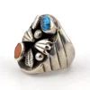 Vintage old pawn style sterling silver ring with turquoise and coral cabochons, raised silver details, and dark patina.