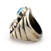 Vintage old pawn style sterling silver ring with turquoise and coral cabochons, raised silver details, and dark patina.