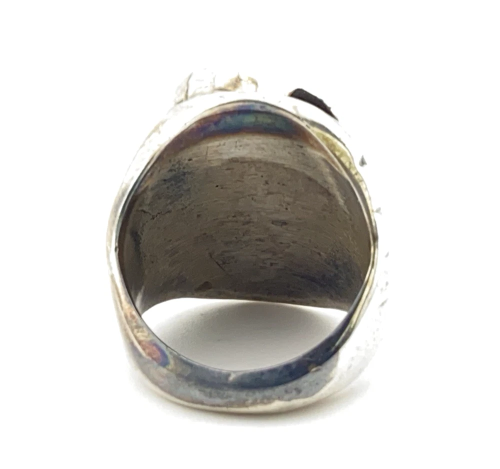 Vintage old pawn style sterling silver ring with turquoise and coral cabochons, raised silver details, and dark patina.