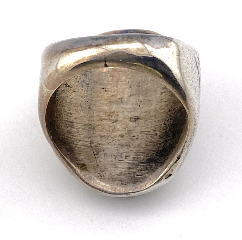Vintage old pawn style sterling silver ring with turquoise and coral cabochons, raised silver details, and dark patina.