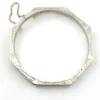 Vintage sterling silver octagonal hinged bangle bracelet with engraved details and safety chain.