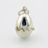 Vintage sterling silver hinged egg pendant charm that opens to reveal a gold vermeil chick inside.
