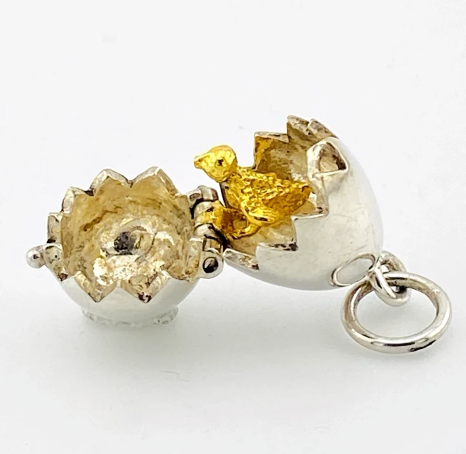 Vintage sterling silver hinged egg pendant charm that opens to reveal a gold vermeil chick inside.