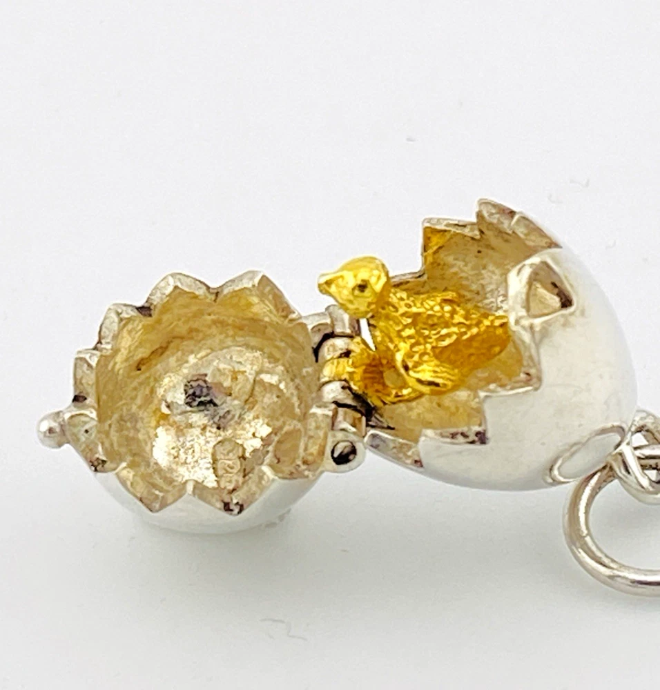 Vintage sterling silver hinged egg pendant charm that opens to reveal a gold vermeil chick inside.