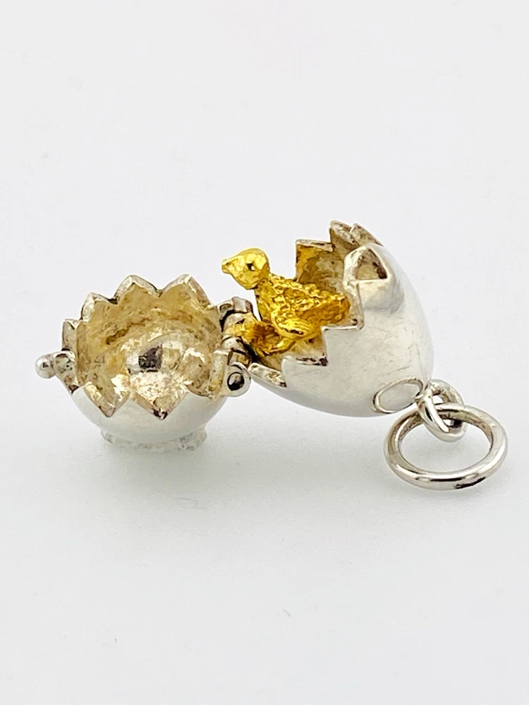 Vintage sterling silver hinged egg pendant charm that opens to reveal a gold vermeil chick inside.