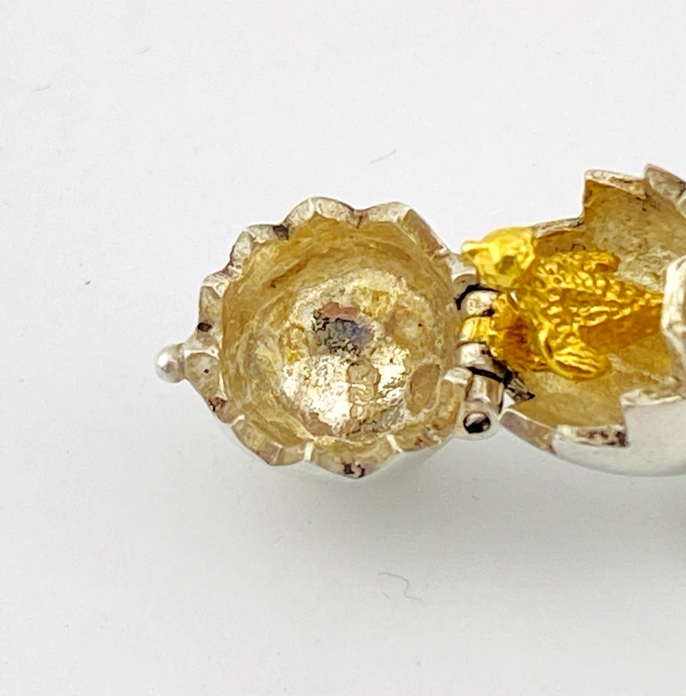 Vintage sterling silver hinged egg pendant charm that opens to reveal a gold vermeil chick inside.