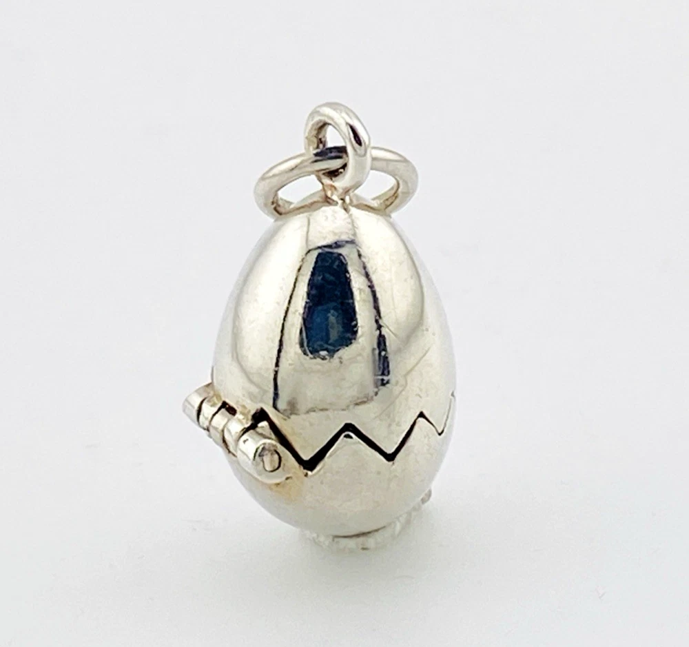 Vintage sterling silver hinged egg pendant charm that opens to reveal a gold vermeil chick inside.