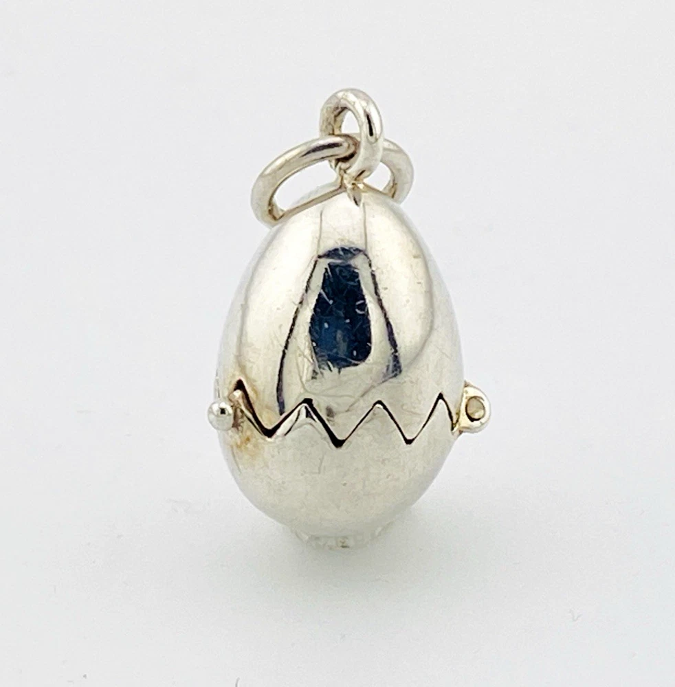 Vintage sterling silver hinged egg pendant charm that opens to reveal a gold vermeil chick inside.