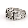 Vintage Uncas men’s Modernist white gold plated ring with open shoulders and a round faceted crystal.