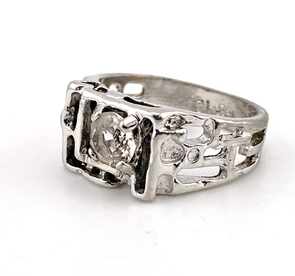 Vintage Uncas men’s Modernist white gold plated ring with open shoulders and a round faceted crystal.
