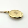 Vintage Winard 1/20 12K gold filled oval locket necklace with diamond accent, chased eight point starburst, and 17 inch curb chain