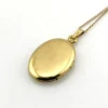 Vintage Winard 1/20 12K gold filled oval locket necklace with diamond accent, chased eight point starburst, and 17 inch curb chain