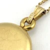 Vintage Winard 1/20 12K gold filled oval locket necklace with diamond accent, chased eight point starburst, and 17 inch curb chain