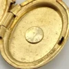 Vintage Winard 1/20 12K gold filled oval locket necklace with diamond accent, chased eight point starburst, and 17 inch curb chain
