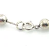 The silver beads are individually strung on a foxtail-style chain
