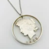 Hand cut Peace Dollar silver coin pendant detail